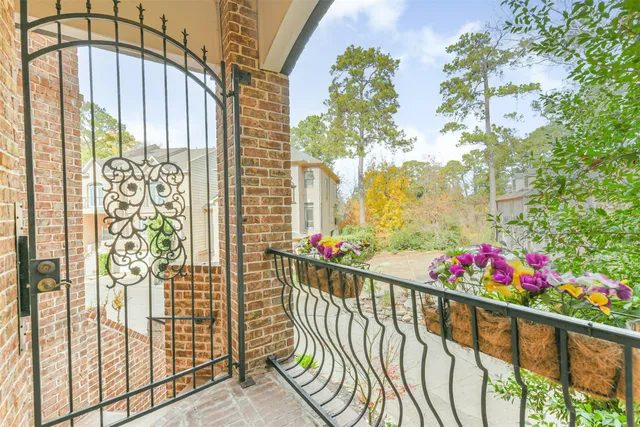 a view of a balcony with flower plants