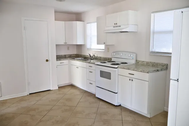 a kitchen with cabinets appliances and a sink
