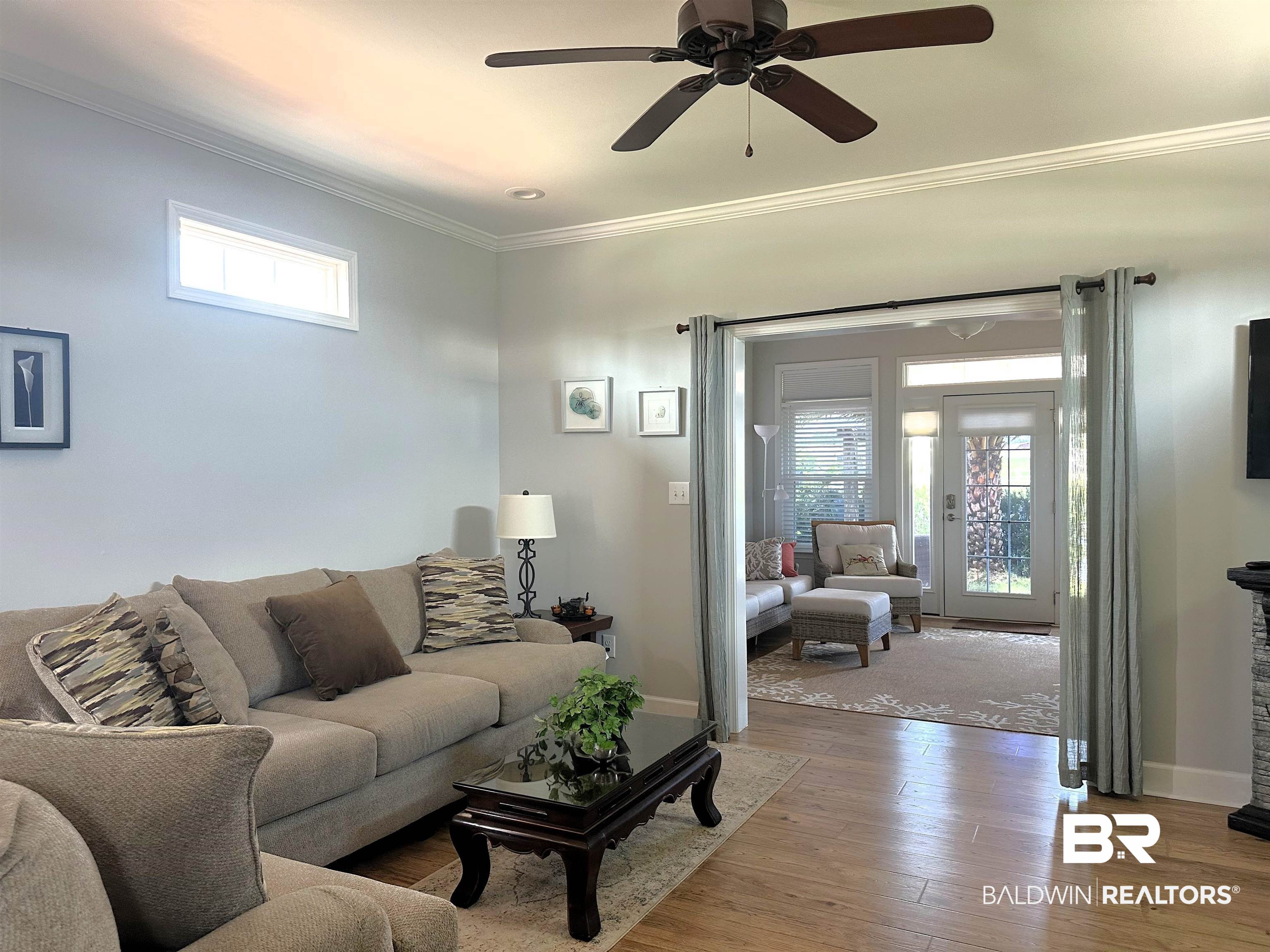 12136 Gateway Drive Elberta, AL 36530 - Photo 12 of 34 Living room with crown molding, hardwood / wood-style flooring, and ceiling fan