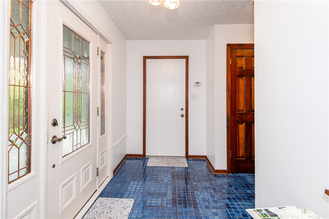 6750 Little Twin Road Germantown, OH 45327 - Photo 34 of 88 This entry welcomes with vibrant blue tile flooring and elegant leaded glass door details.