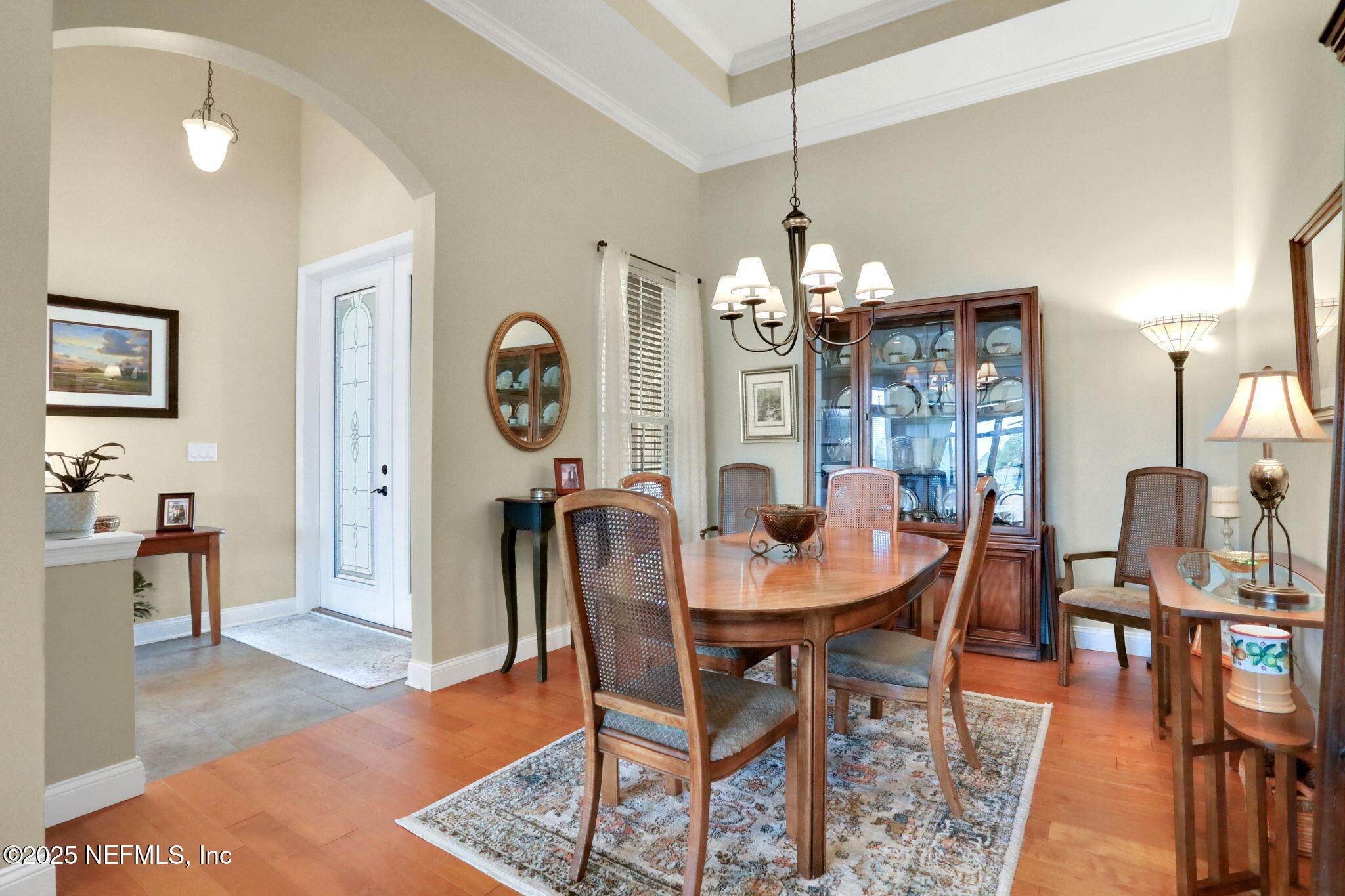 1016 Inverness Drive St. Augustine, FL 32092 - Photo 17 of 59 a dining room with furniture a chandelier and wooden floor