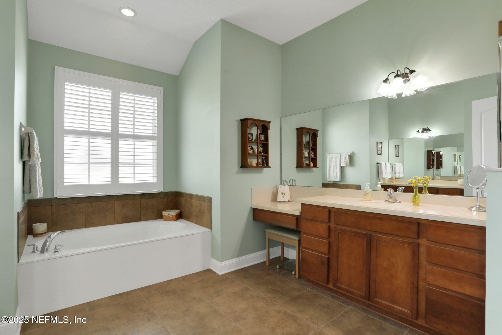 1016 Inverness Drive St. Augustine, FL 32092 - Photo 21 of 59 a spacious bathroom with a bathtub a double vanity sink and mirror