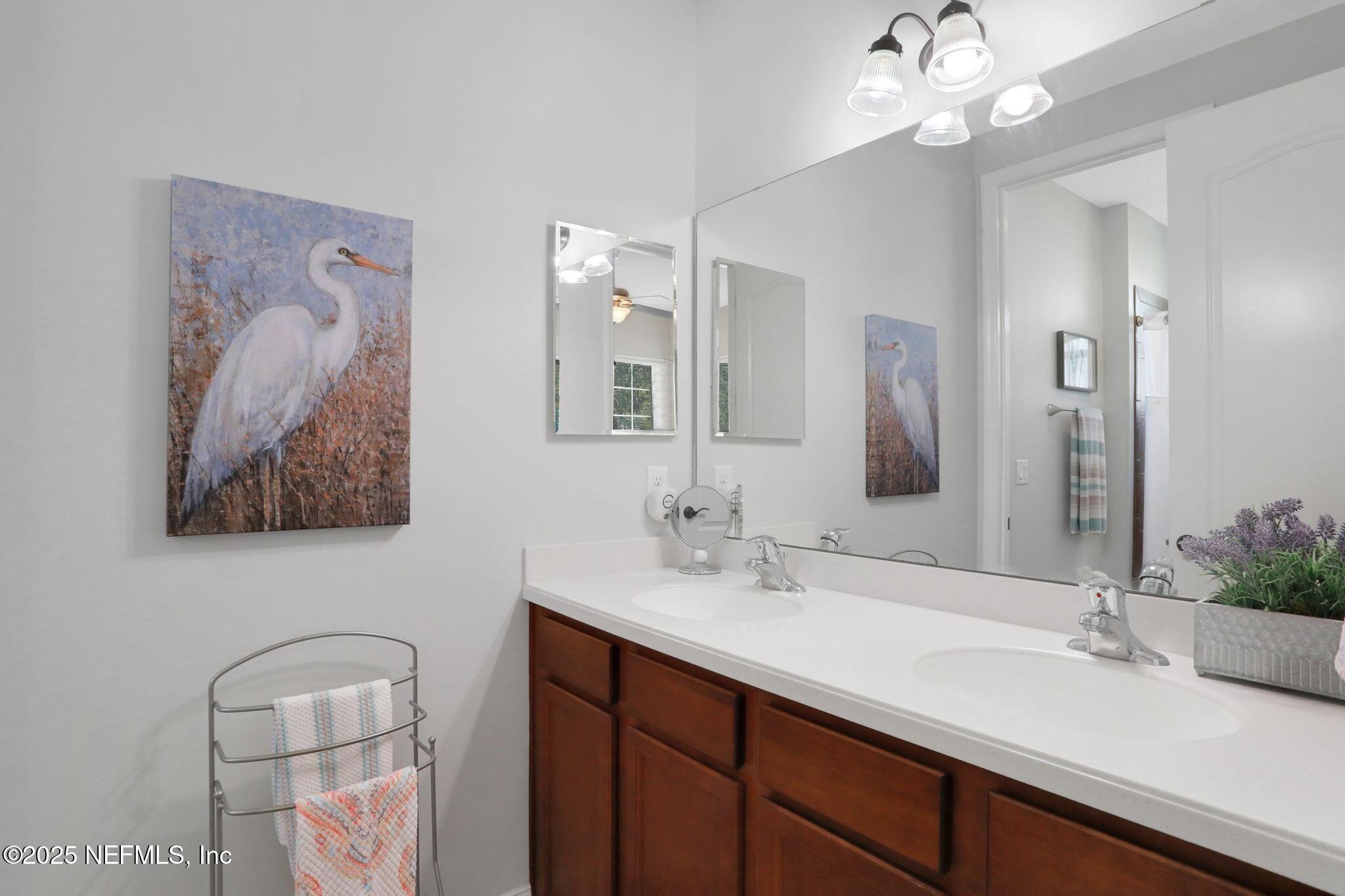 1016 Inverness Drive St. Augustine, FL 32092 - Photo 27 of 59 a bathroom with a double vanity sink and a mirror