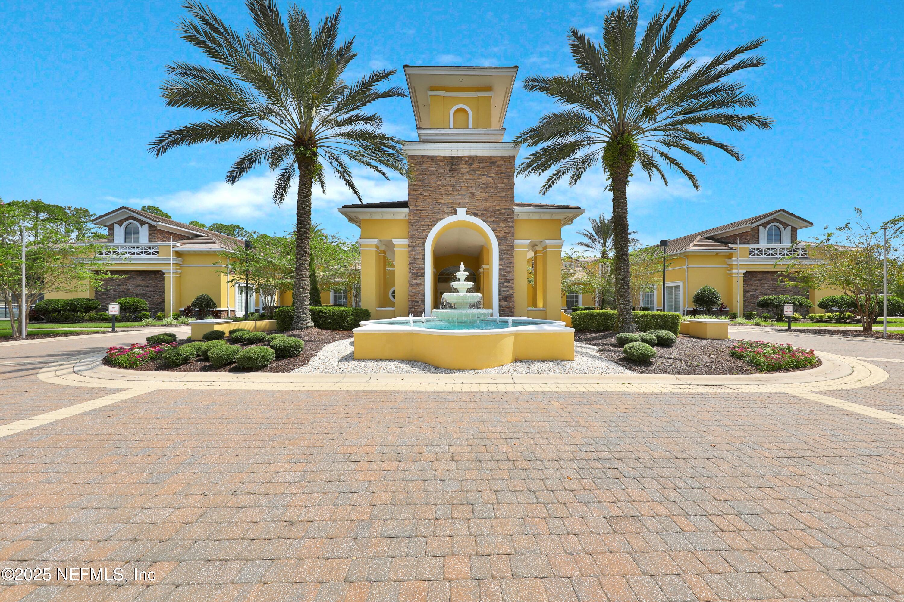 1016 Inverness Drive St. Augustine, FL 32092 - Photo 38 of 59 a view of a building with a yard and palm trees