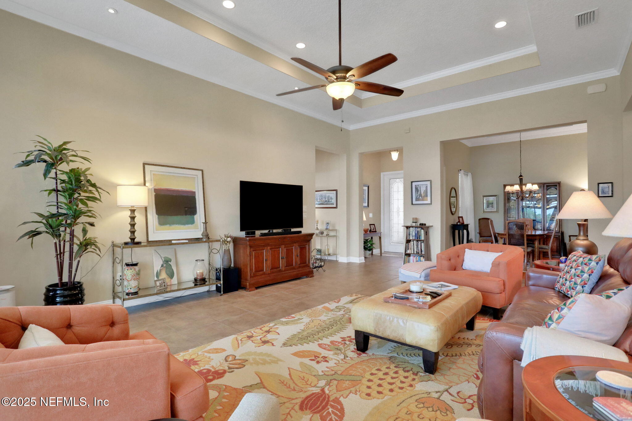 1016 Inverness Drive St. Augustine, FL 32092 - Photo 5 of 59 a living room with furniture a flat screen tv and a chandelier