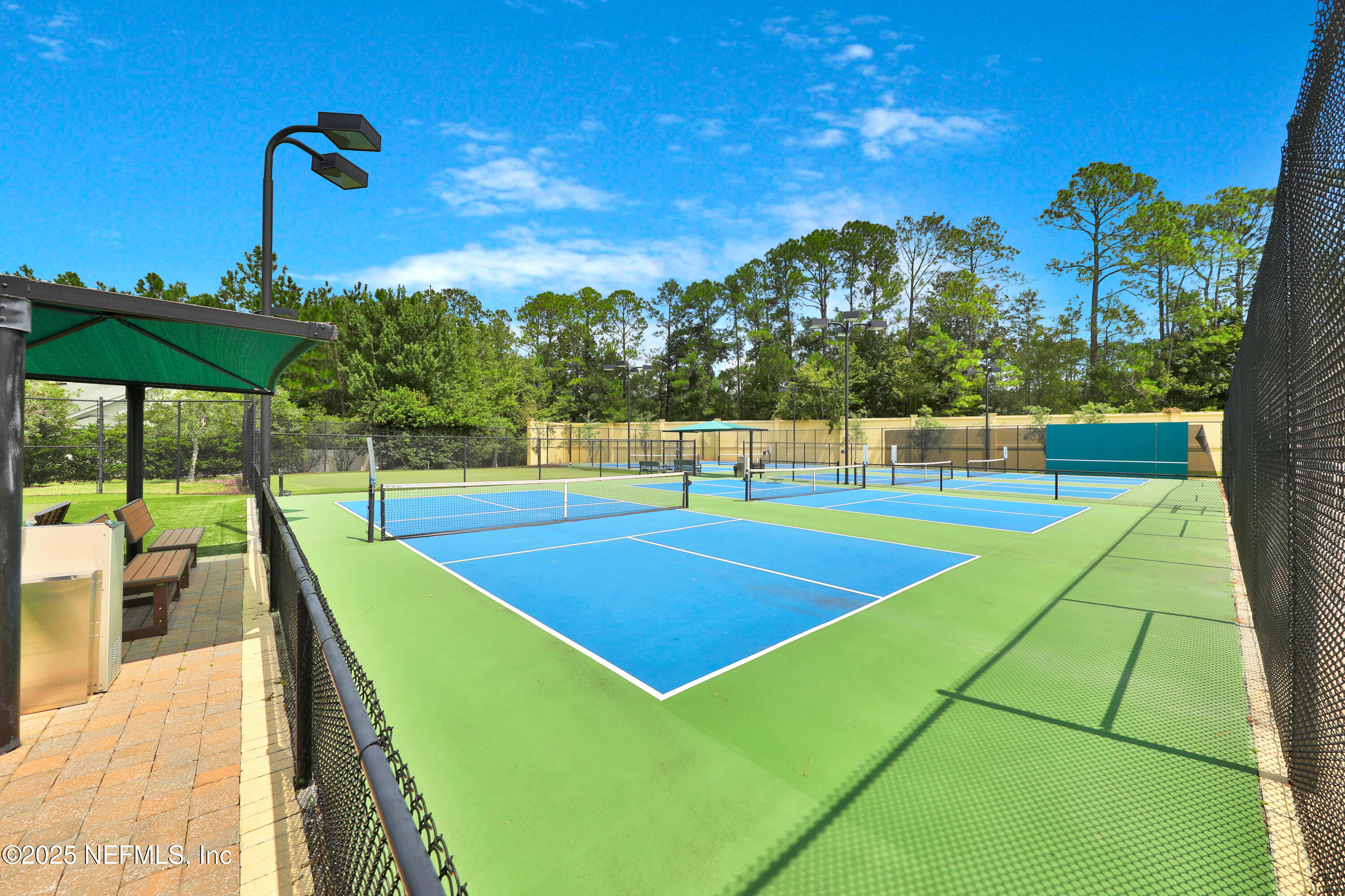 1016 Inverness Drive St. Augustine, FL 32092 - Photo 56 of 59 a view of a tennis court with a large pool in the background