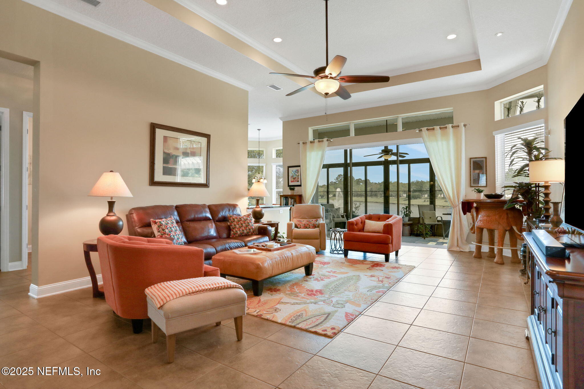 1016 Inverness Drive St. Augustine, FL 32092 - Photo 7 of 59 a living room with furniture and a floor to ceiling window