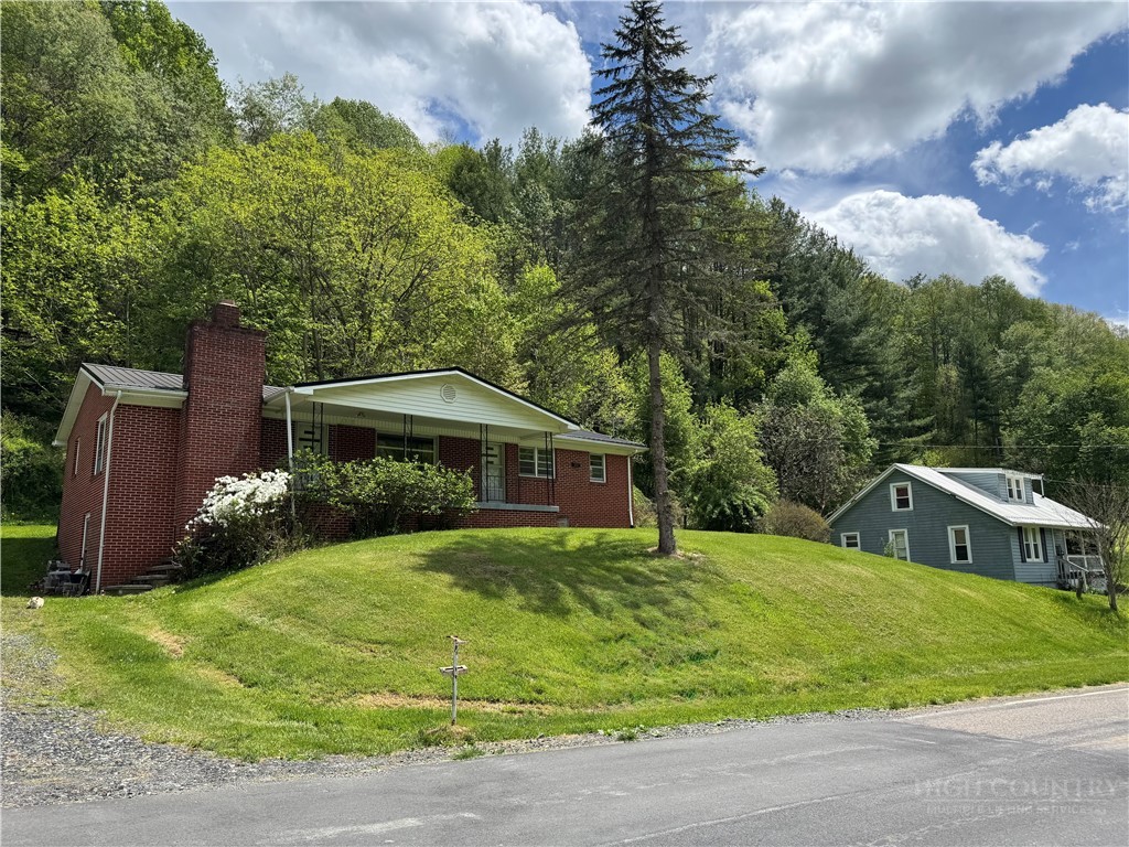 2510 Rich Hill Road Creston, NC 28615 - Photo 38 of 38 a view of a house with a yard and sitting area