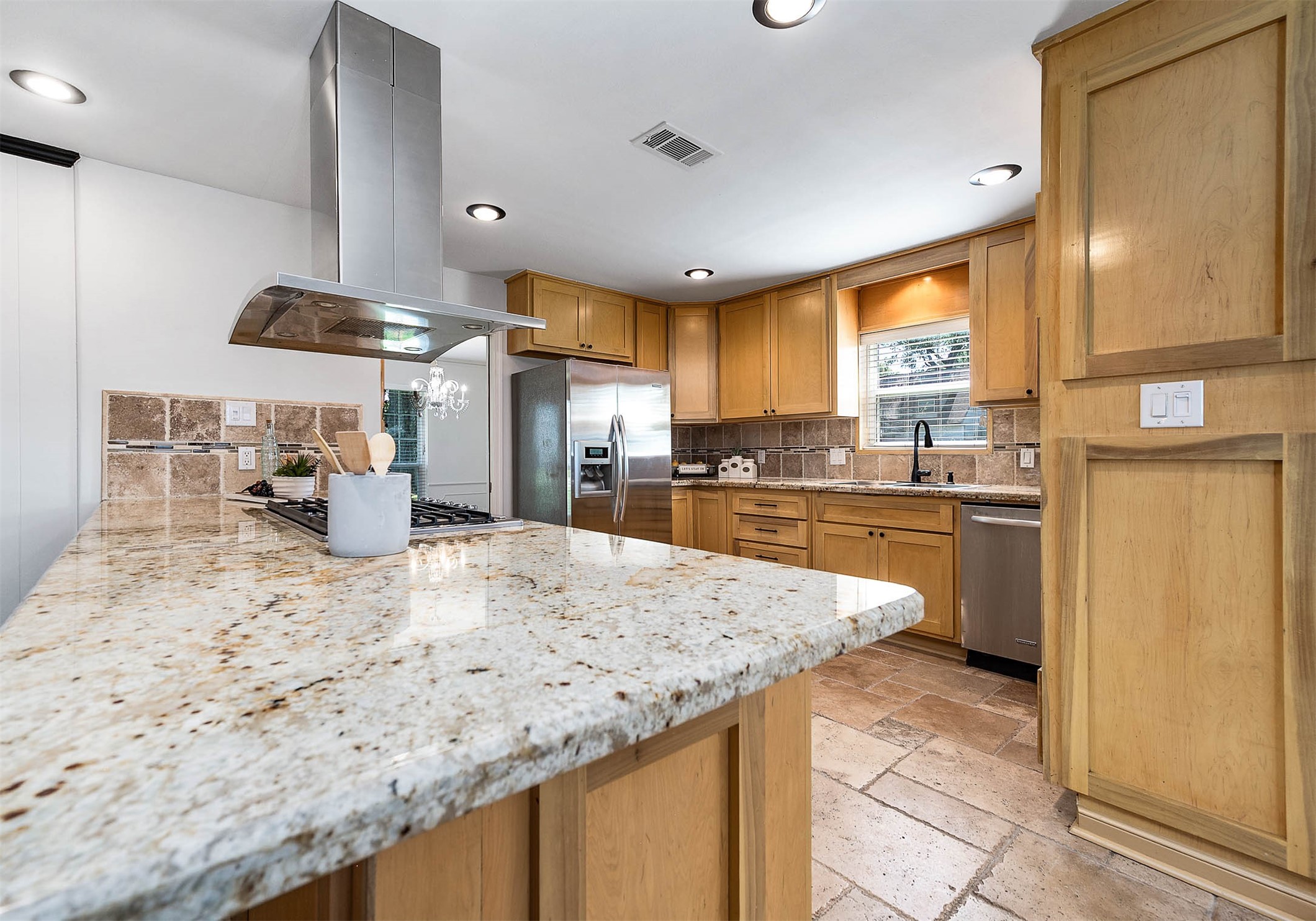 2103 Southwick Street Houston, TX 77080 - Photo 11 of 49 a kitchen with stainless steel appliances granite countertop a sink refrigerator and cabinets