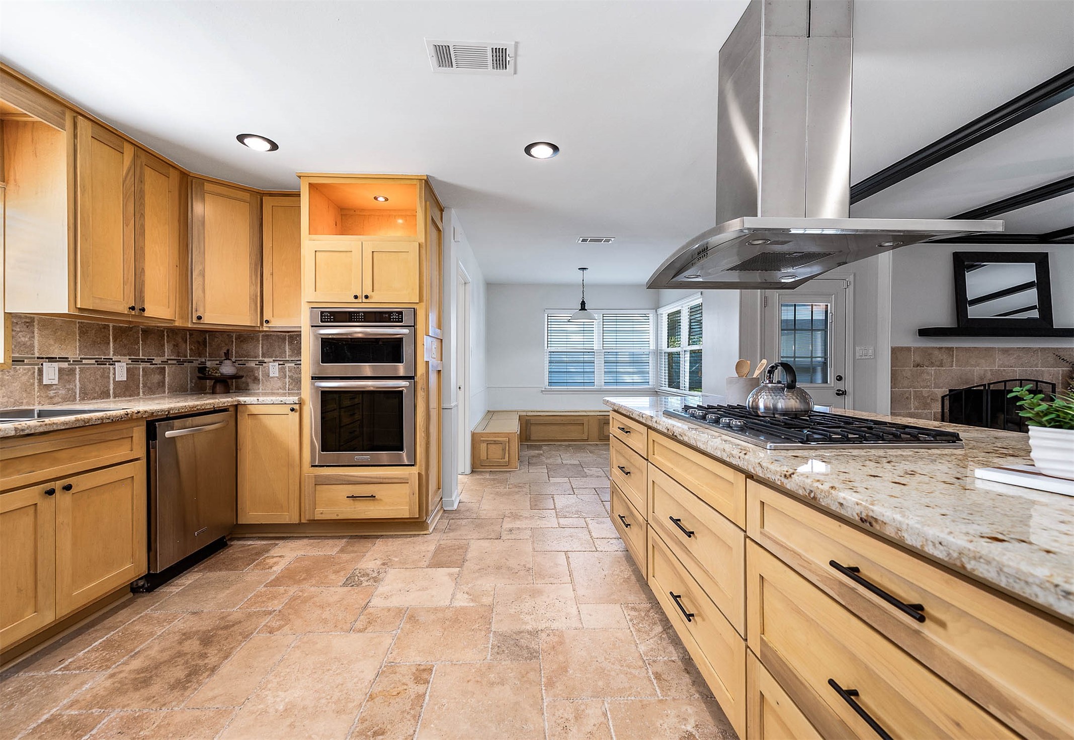 2103 Southwick Street Houston, TX 77080 - Photo 13 of 49 a large kitchen with stainless steel appliances granite countertop a stove and a sink