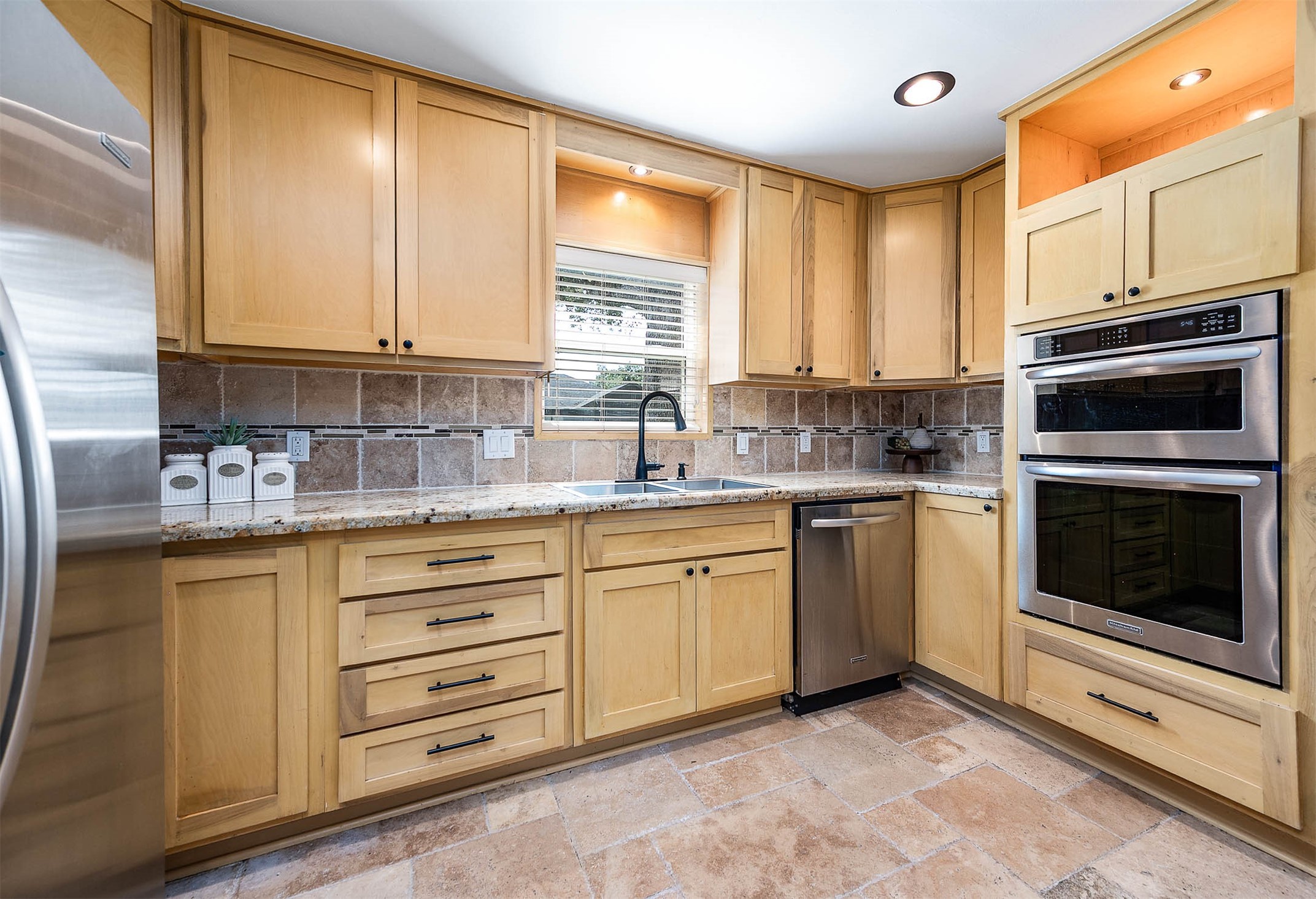 2103 Southwick Street Houston, TX 77080 - Photo 14 of 49 a kitchen with granite countertop a sink stainless steel appliances and cabinets