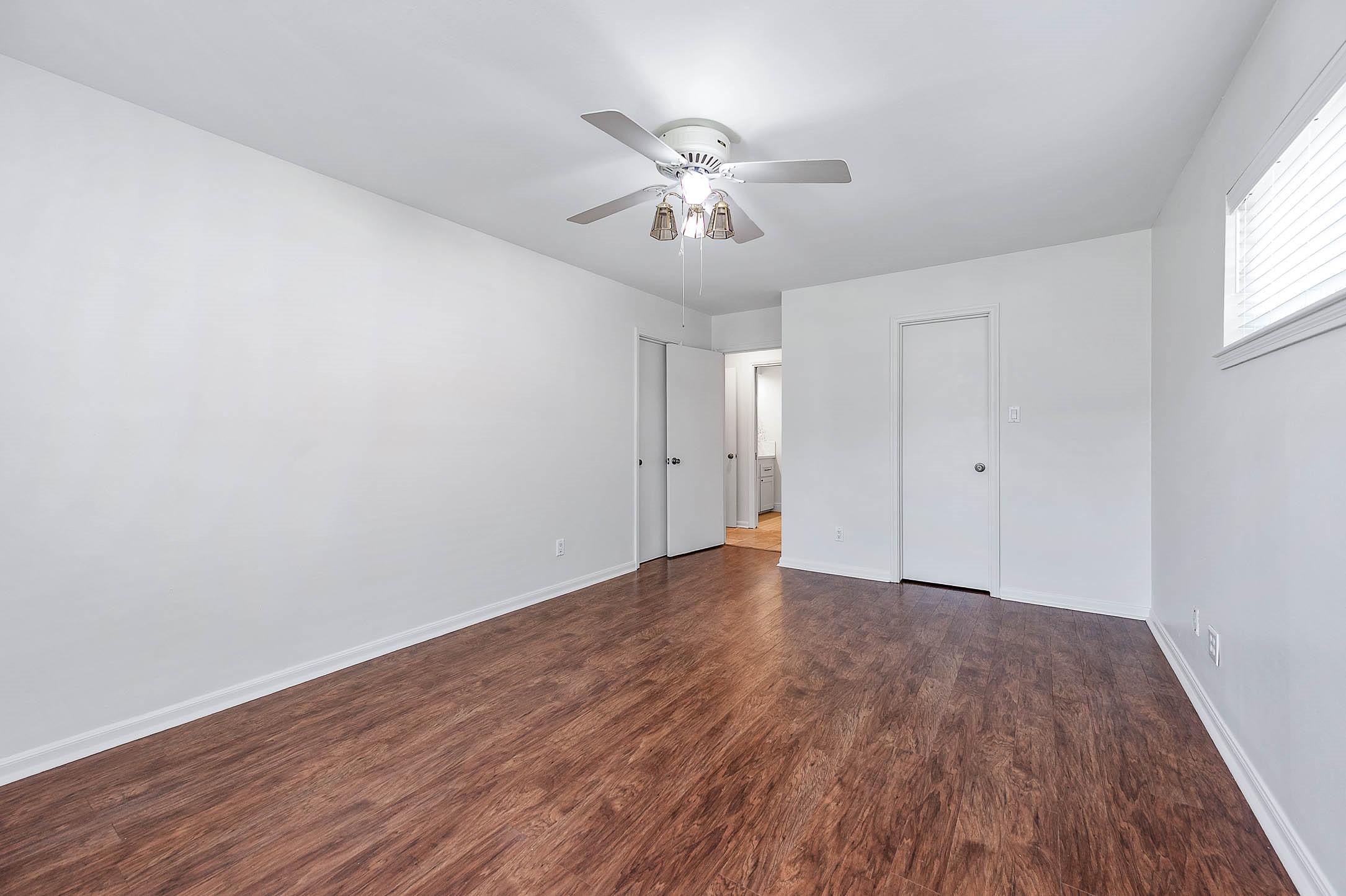 2103 Southwick Street Houston, TX 77080 - Photo 17 of 49 a view of an empty room with wooden floor and a window
