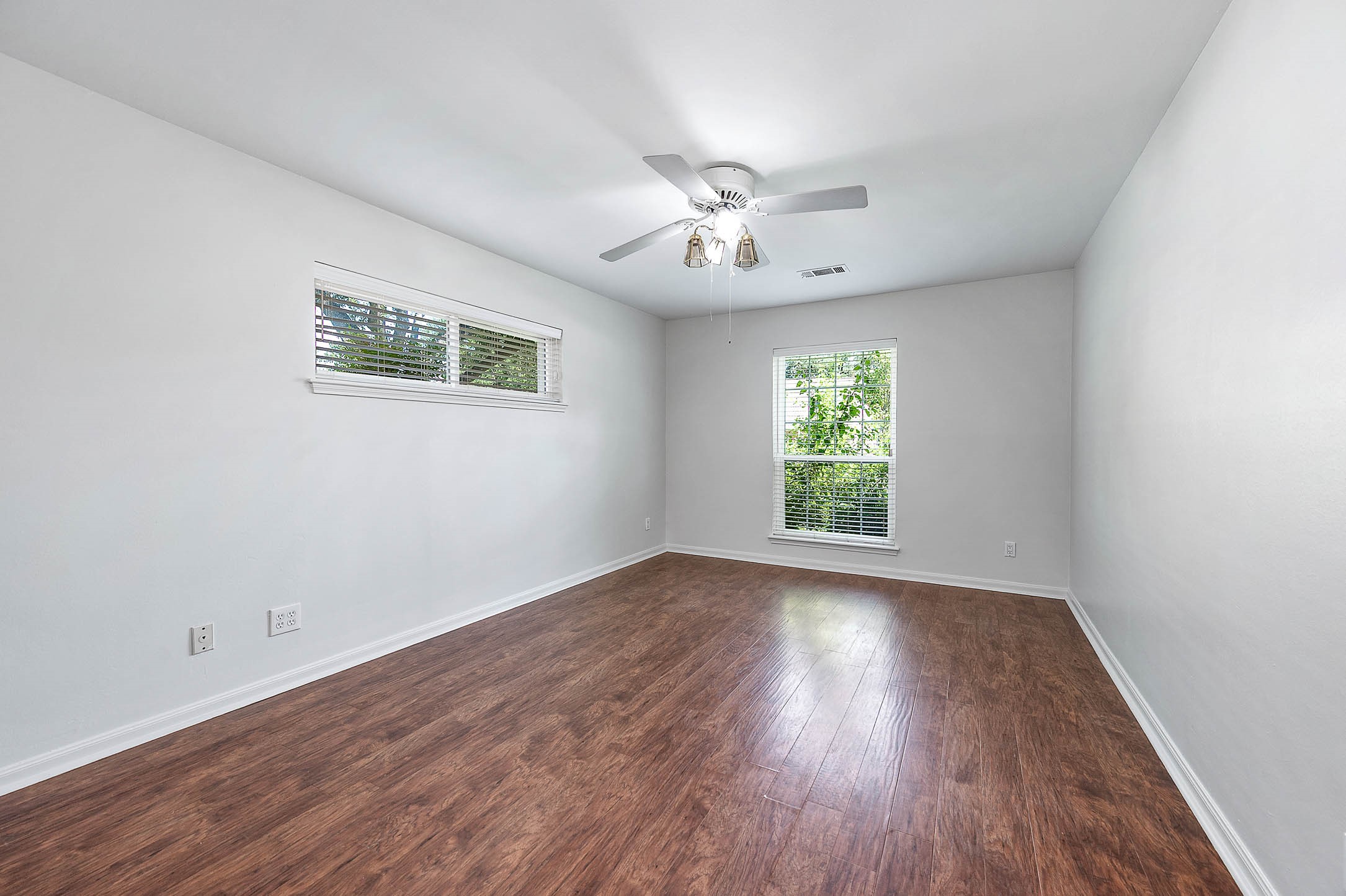 2103 Southwick Street Houston, TX 77080 - Photo 19 of 49 a view of an empty room with wooden floor and a window