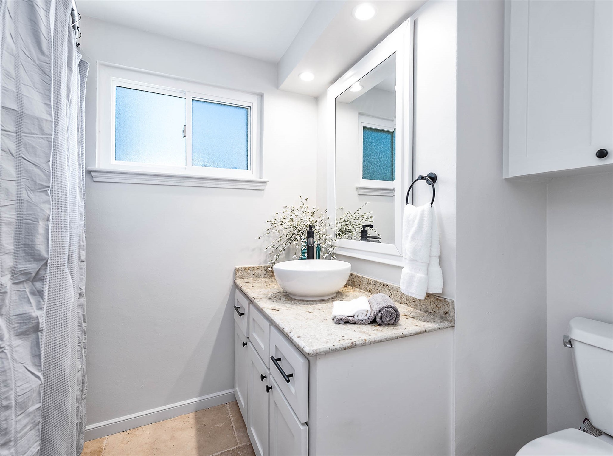 2103 Southwick Street Houston, TX 77080 - Photo 25 of 49 a bathroom with a granite countertop sink and a mirror