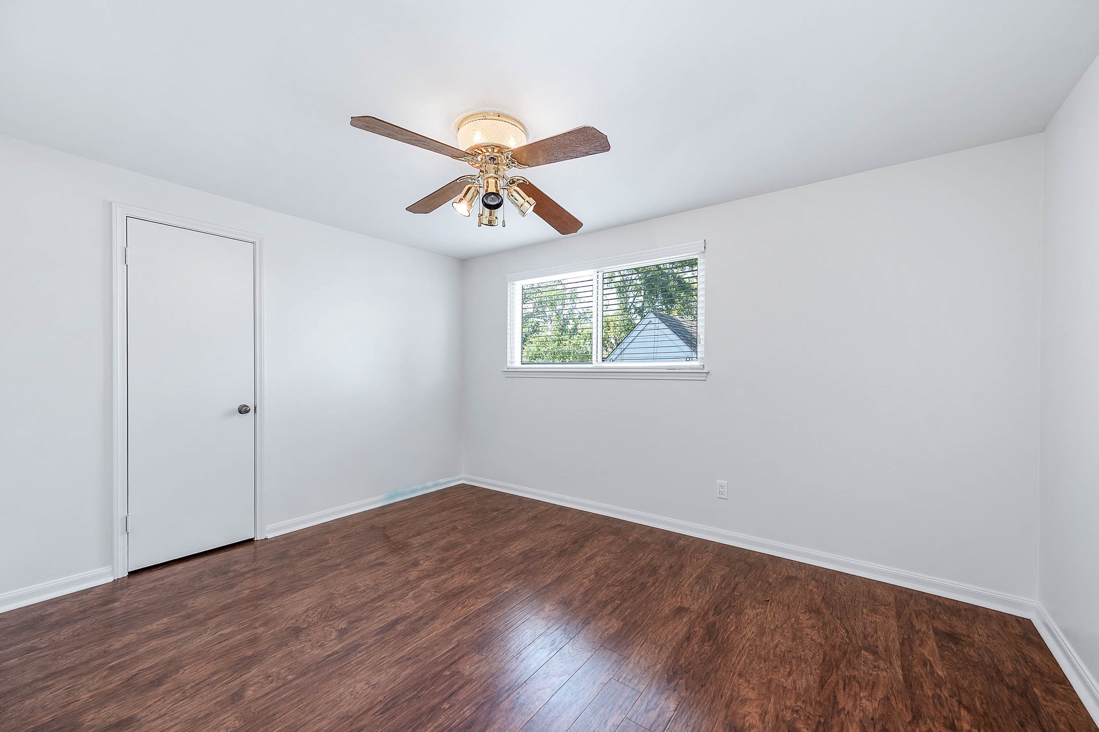 2103 Southwick Street Houston, TX 77080 - Photo 26 of 49 an empty room with wooden floor chandelier fan and windows