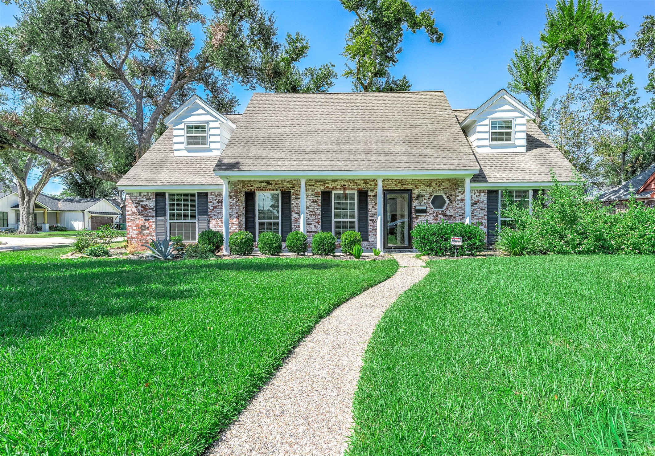 2103 Southwick Street Houston, TX 77080 - Photo 3 of 49 a view of house with garden and tall trees