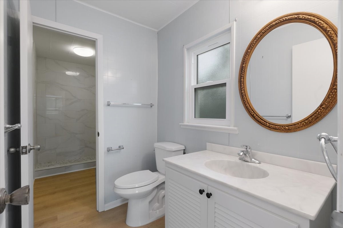 2103 Southwick Street Houston, TX 77080 - Photo 34 of 49 a bathroom with a sink a toilet and a mirror