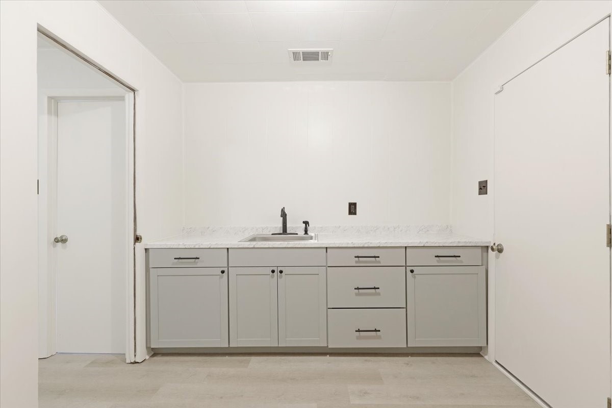 2103 Southwick Street Houston, TX 77080 - Photo 37 of 49 a view of cabinets a sink and a stove in a kitchen