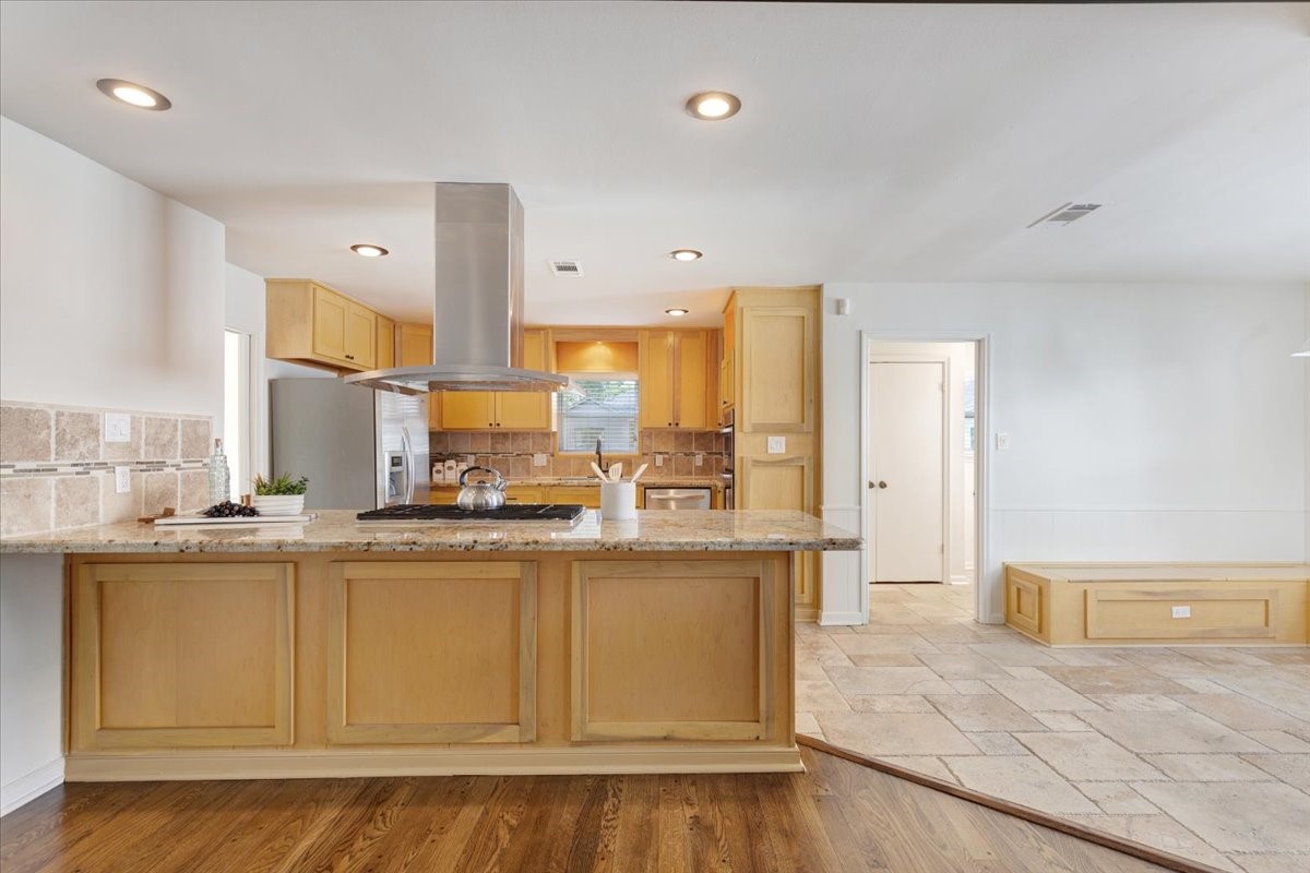 2103 Southwick Street Houston, TX 77080 - Photo 10 of 49 a kitchen with stainless steel appliances granite countertop a stove a sink and a refrigerator
