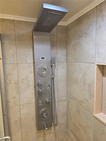 a bathroom with a shower and a mirror