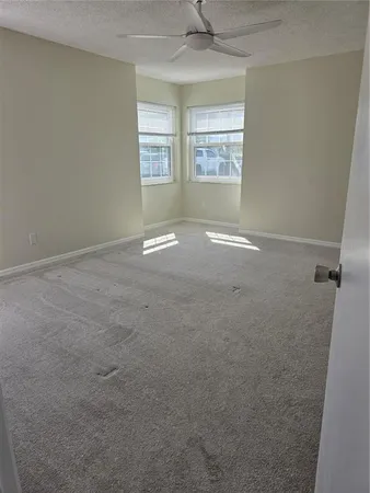 an empty room with windows and closet