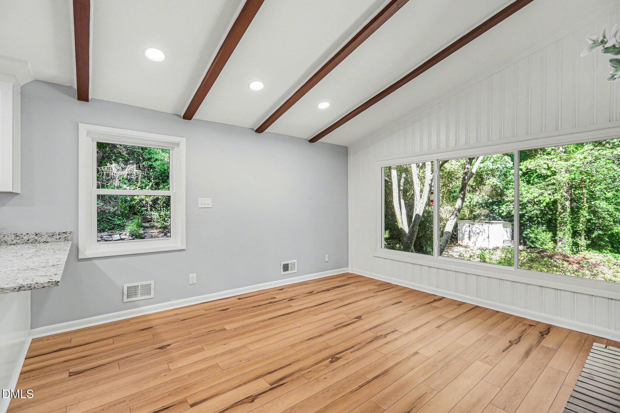 2600 Wade Avenue Raleigh, NC 27607 - Photo 8 of 31 a view of an empty room with wooden floor and a window