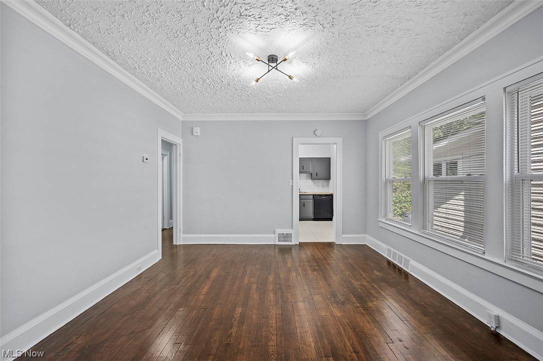 2174 Oakdale Road Cleveland, OH 44118 - Photo 6 of 35 Wood floored empty room featuring crown molding and a textured ceiling