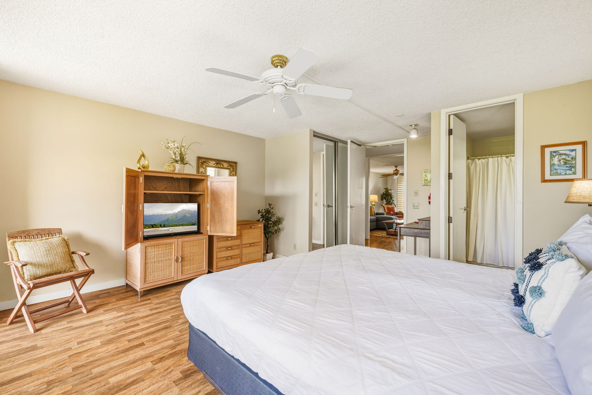 3811 Edward Road, Unit 1206 Princeville, HI 96722 - Photo 6 of 30 a bedroom with a bed and a chair