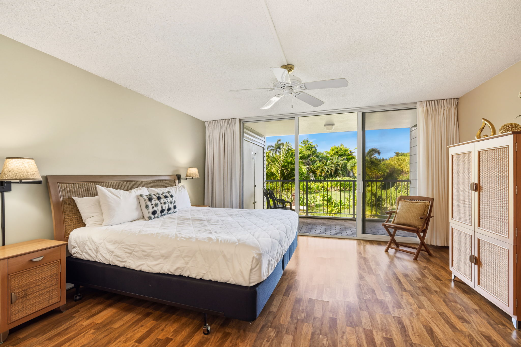 3811 Edward Road, Unit 1206 Princeville, HI 96722 - Photo 7 of 30 a bedroom with a bed wooden floor and large window