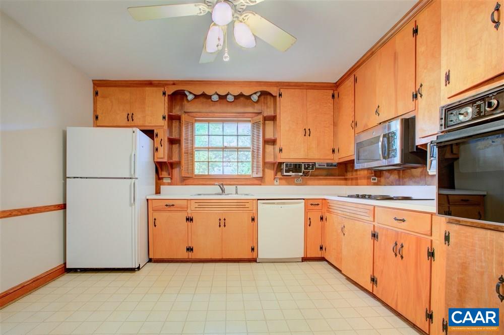 2808 Northfield Road Charlottesville, VA 22901 - Photo 11 of 30 a kitchen with granite countertop stainless steel appliances a refrigerator a sink and white cabinets