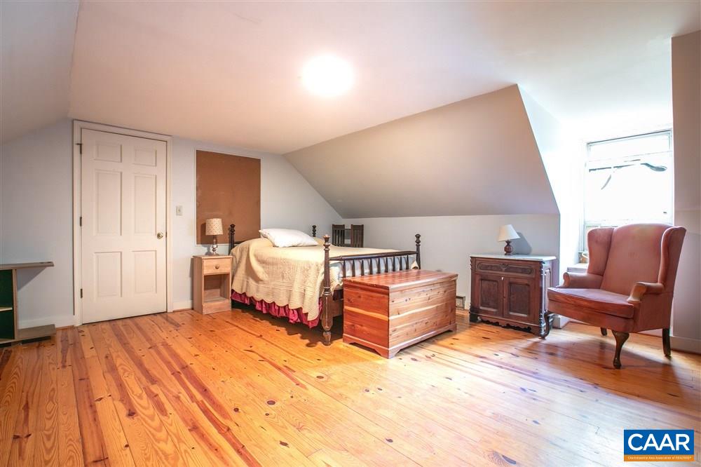 2808 Northfield Road Charlottesville, VA 22901 - Photo 19 of 30 a spacious bedroom with a bed and a chair in it