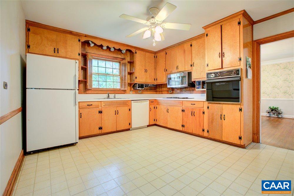 2808 Northfield Road Charlottesville, VA 22901 - Photo 10 of 30 a kitchen with stainless steel appliances granite countertop a refrigerator a sink dishwasher and white cabinets with wooden floor