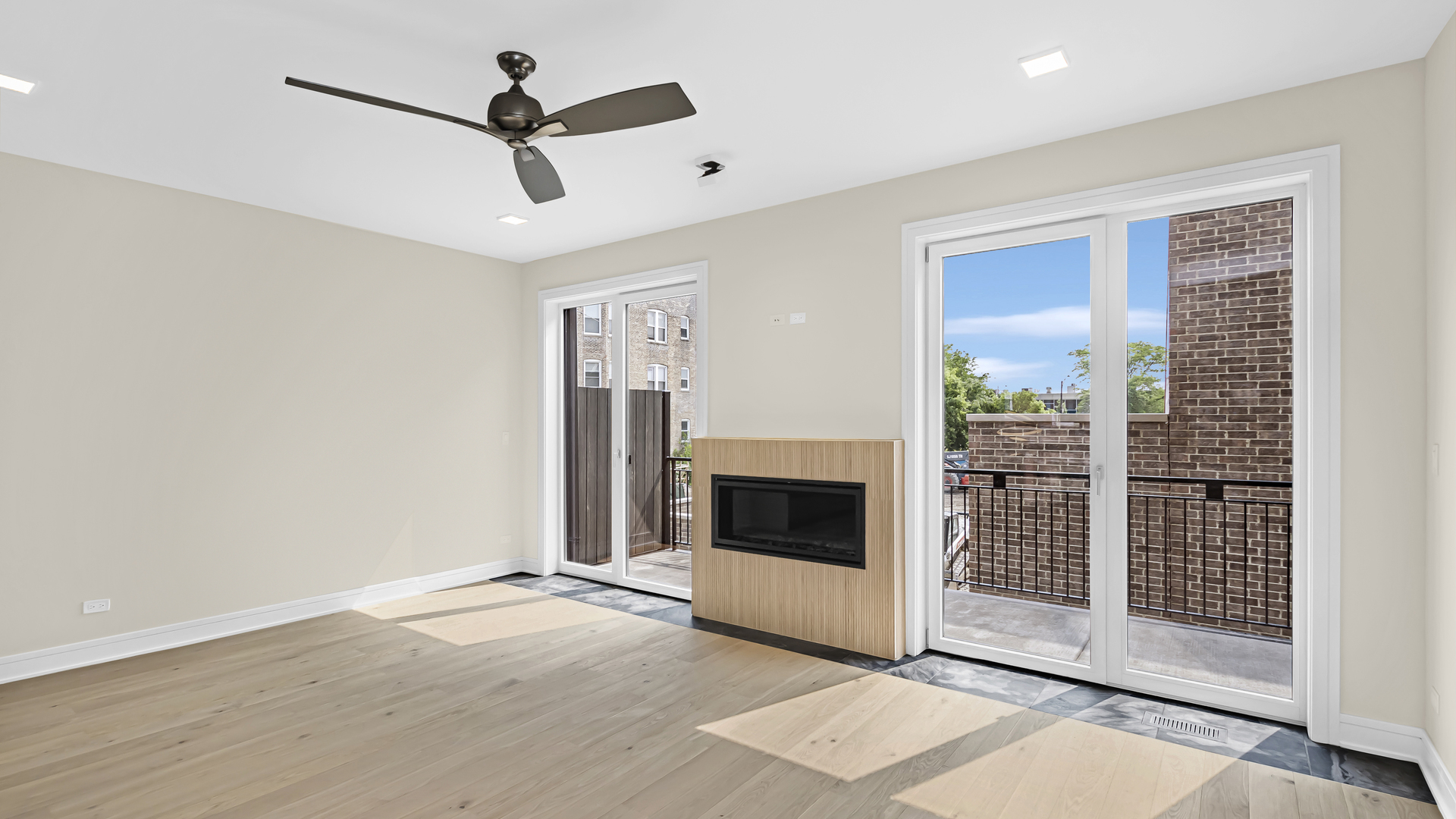 338 East Pershing Road Chicago, IL 60653 - Photo 14 of 44 a view of a livingroom with a ceiling fan a fireplace and a window