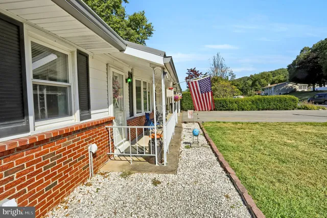 a view of a chairs setting in back yard of a house