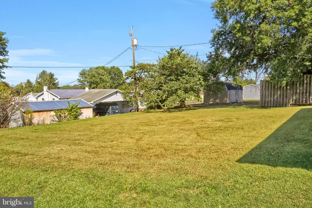 a swimming pool with an outdoor space and seating area