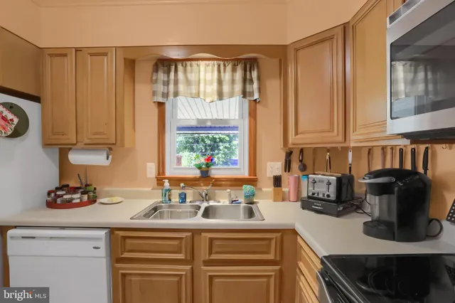 a kitchen with a sink cabinets and a window