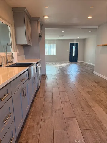 a large kitchen with stainless steel appliances granite countertop a refrigerator a sink and a stove