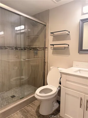 a bathroom with a toilet a sink and shower