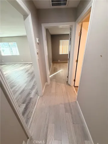a view of a hallway view with wooden floor and staircase