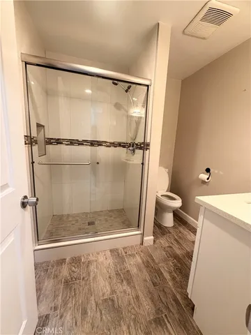 a bathroom with a shower and a toilet