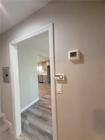 a view of a hallway with wooden floor