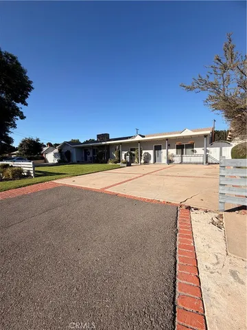a view of swimming pool with outdoor seating and yard in the back