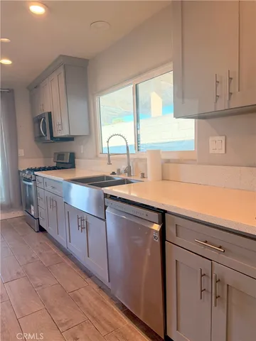 a kitchen with cabinets a sink and appliances