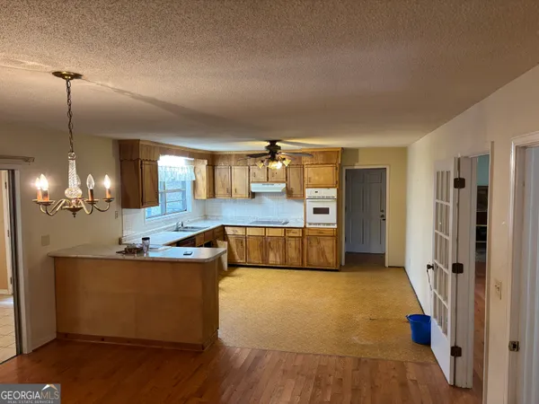 a large kitchen with stainless steel appliances kitchen island a large counter top and sink