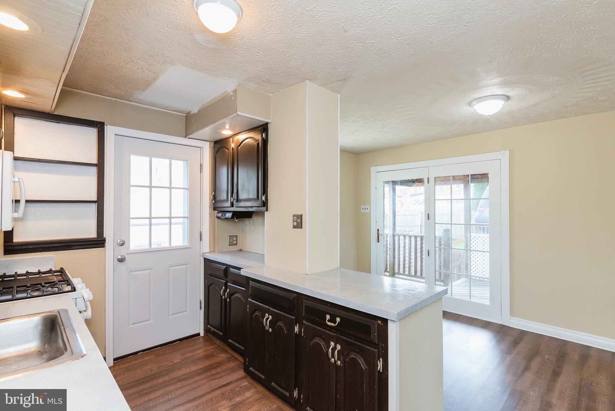 7446 Berkshire Road Baltimore, MD 21224 - Photo 14 of 47 Kitchen with breakfast bar into Dining Room