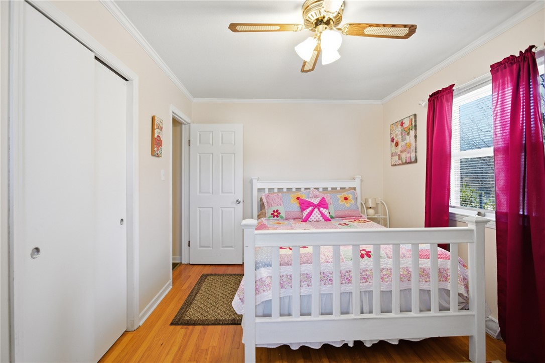 108 Hodge Street Abbeville, SC 29620 - Photo 19 of 39 Hardwood flooring extends throughout this naturally illuminated bedroom with a ceiling fan.