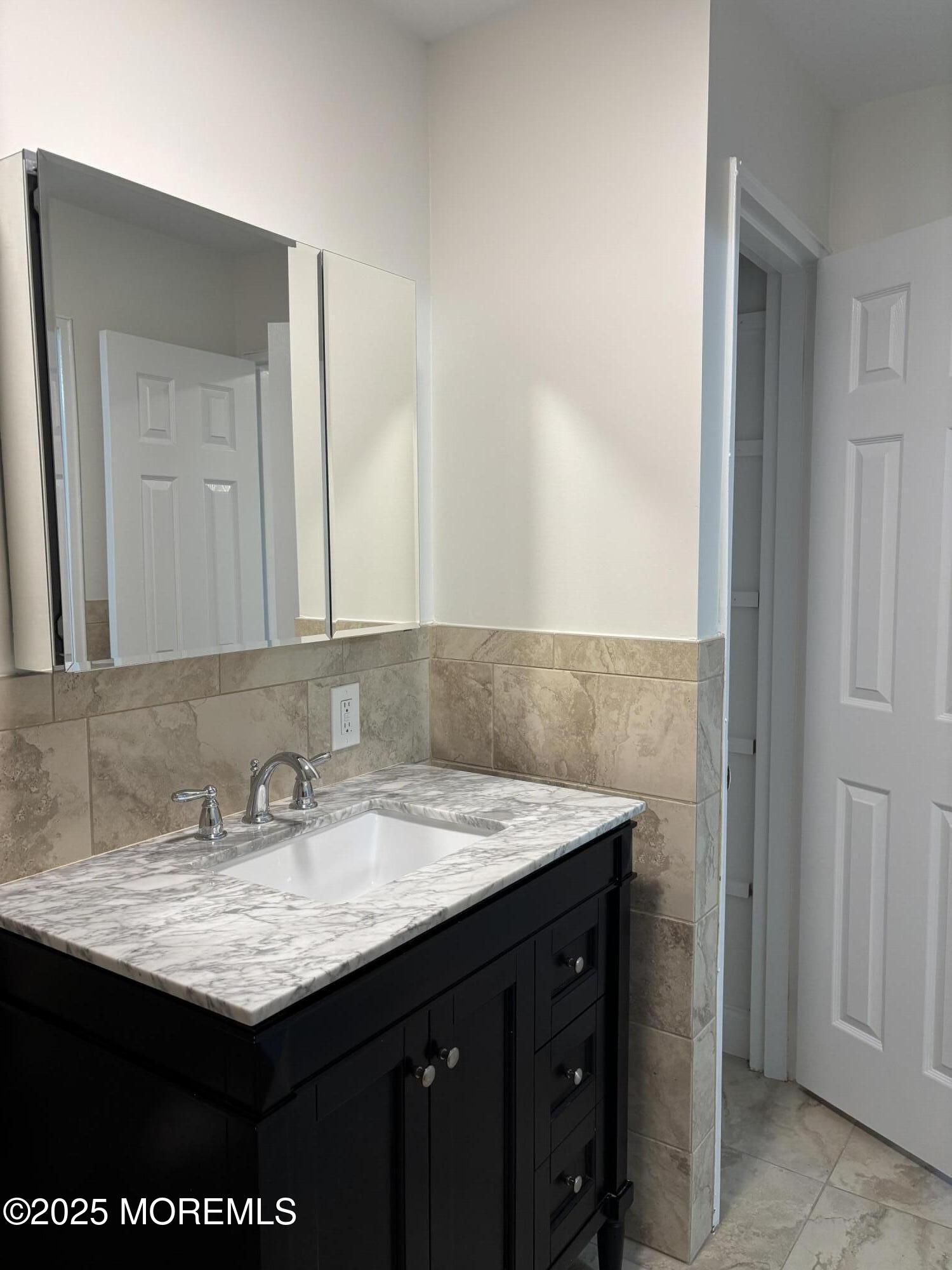 159 Village Green Way Hazlet, NJ 07730 - Photo 12 of 17 a bathroom with a granite countertop sink and a mirror