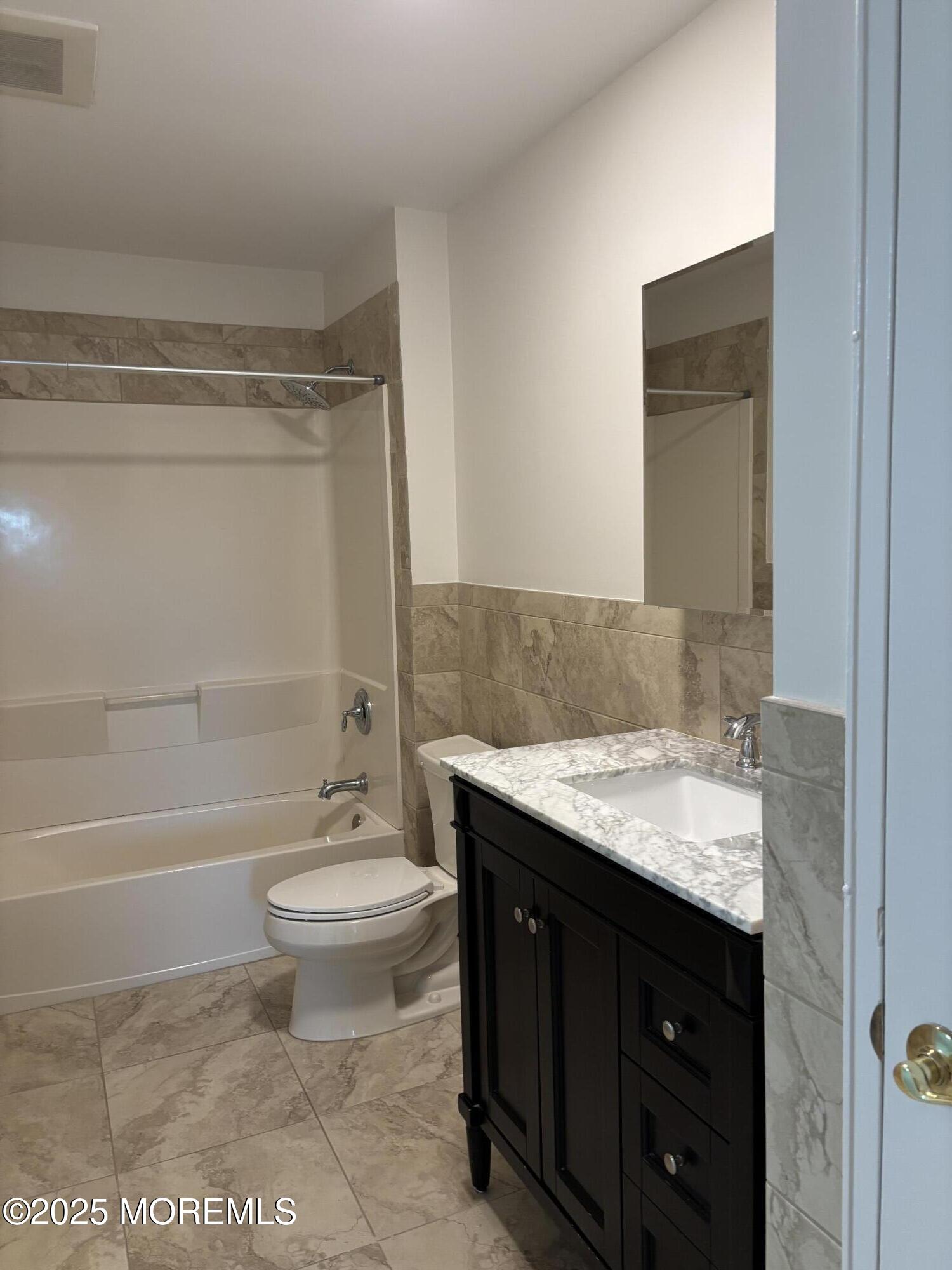 159 Village Green Way Hazlet, NJ 07730 - Photo 13 of 17 a bathroom with a granite countertop toilet a sink and a bathtub