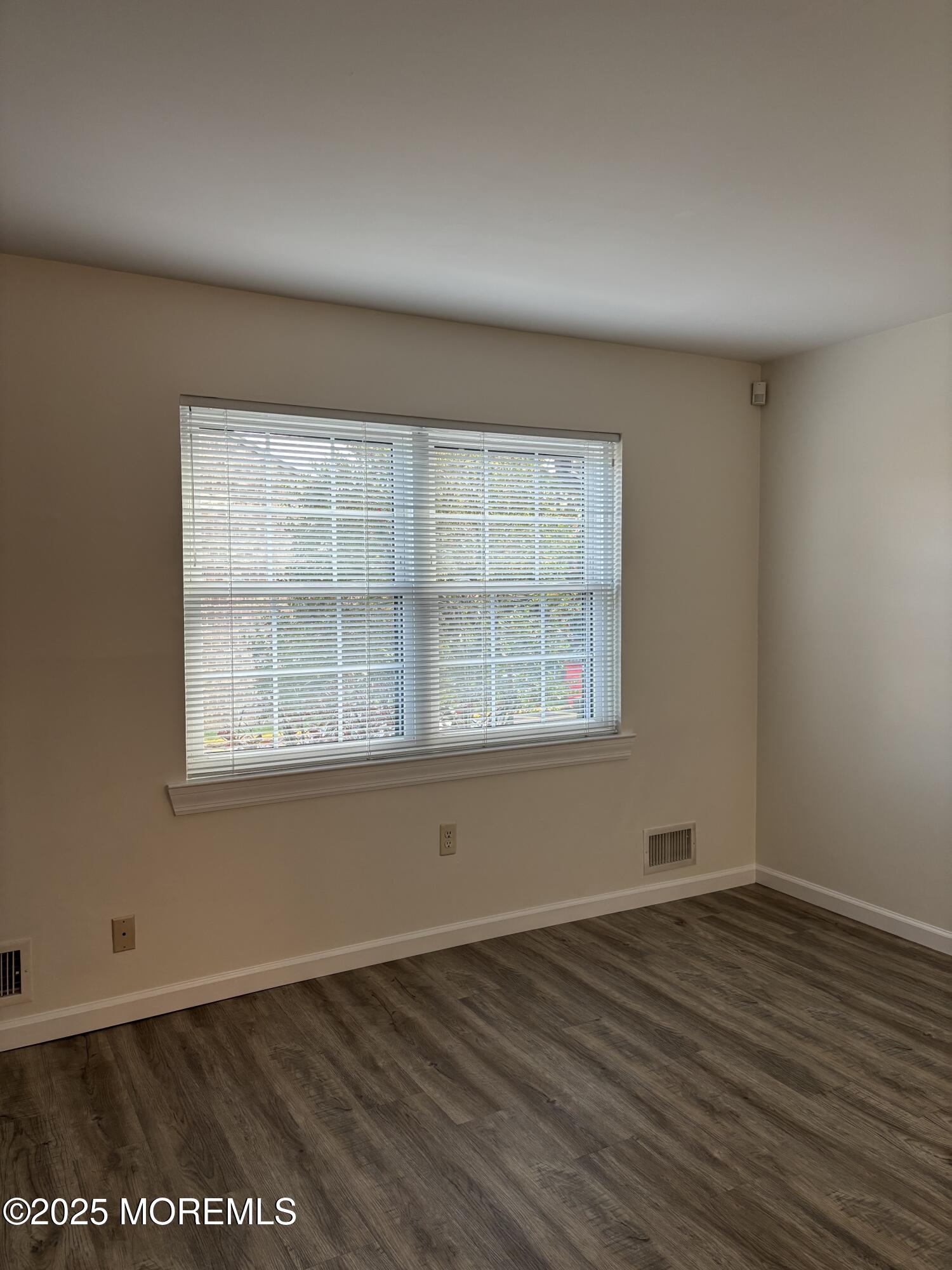 159 Village Green Way Hazlet, NJ 07730 - Photo 2 of 17 an empty room with wooden floor and windows