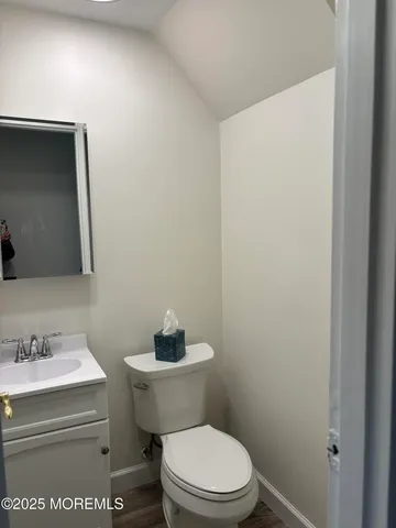 a white toilet sitting next to a bathroom sink